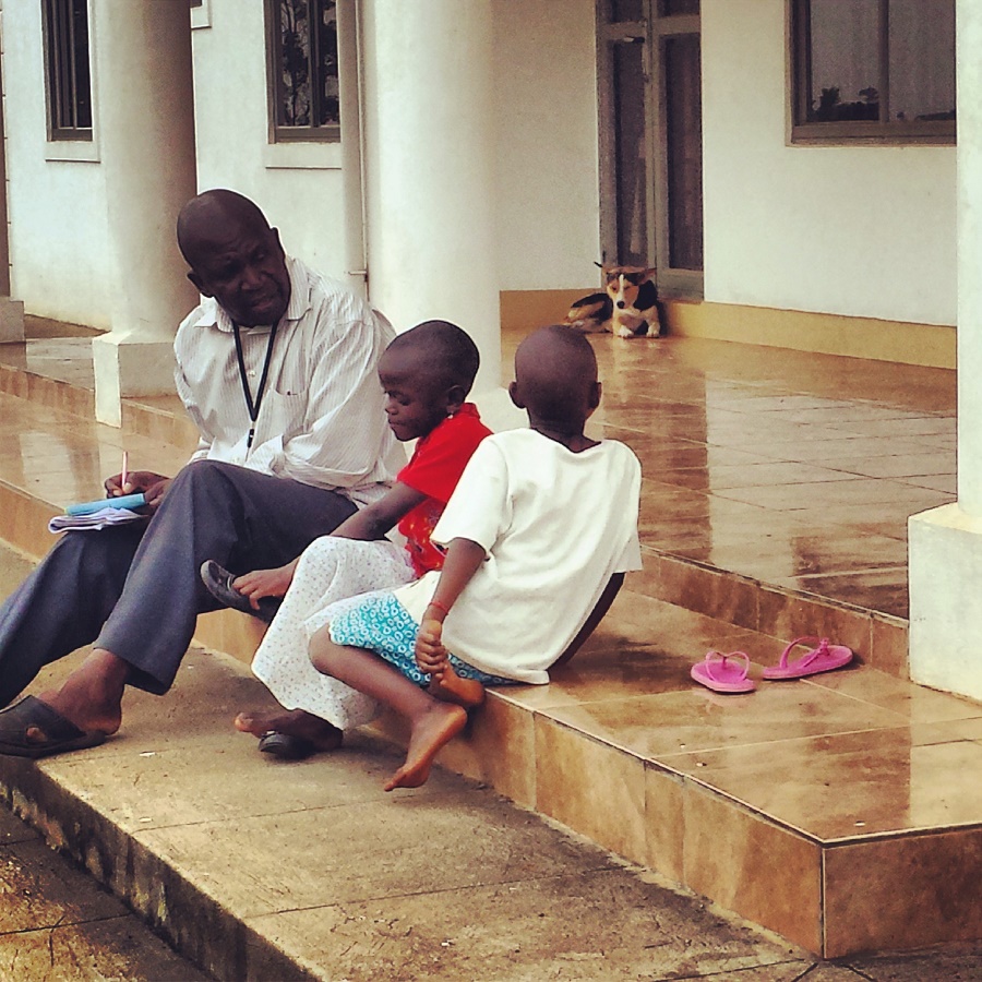 Joseph Kkonde, CARITAS' Coordinator in Uganda, interviewing two children for sponsorship