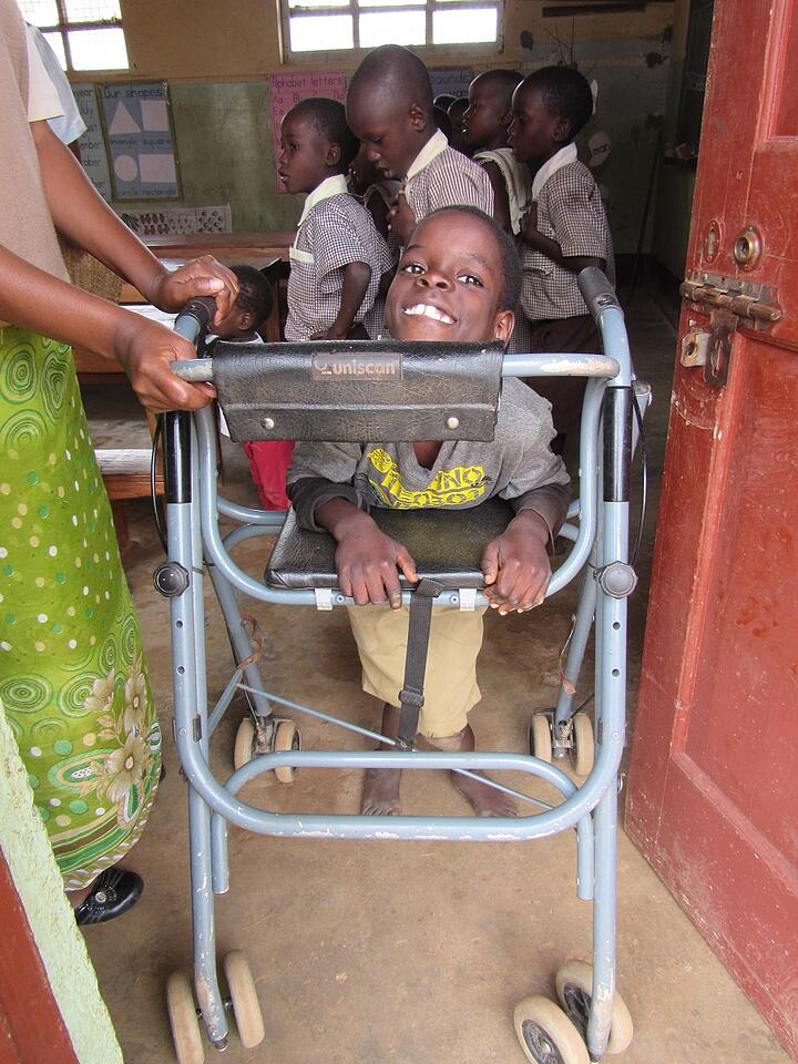 Solomon uses his walker, acquired at Providence Home, to get around in the classroom. Trips outside of the classroom, however, such as walking to the bathroom or the playground, remain a struggle. Solomon uses his walker, acquired at Providence Home, to get around in the classroom. Trips outside of the classroom, however, such as walking to the bathroom or the playground, remain a struggle.