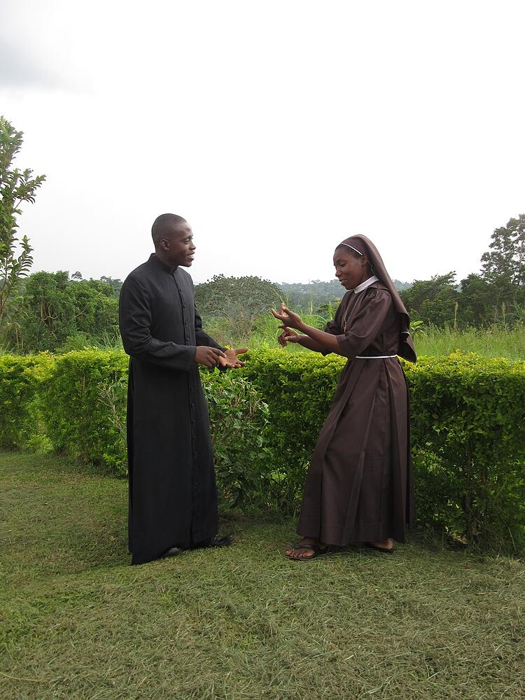 Sr. Carolyne, CARITAS Program Coordinator-Nkokonjeru, and Frank discuss necessary home visits for candidates of our Catholic child sponsorship programs. Sr. Carolyne, CARITAS Program Coordinator-Nkokonjeru, and Frank discuss necessary home visits for candidates of our Catholic child sponsorship programs.
